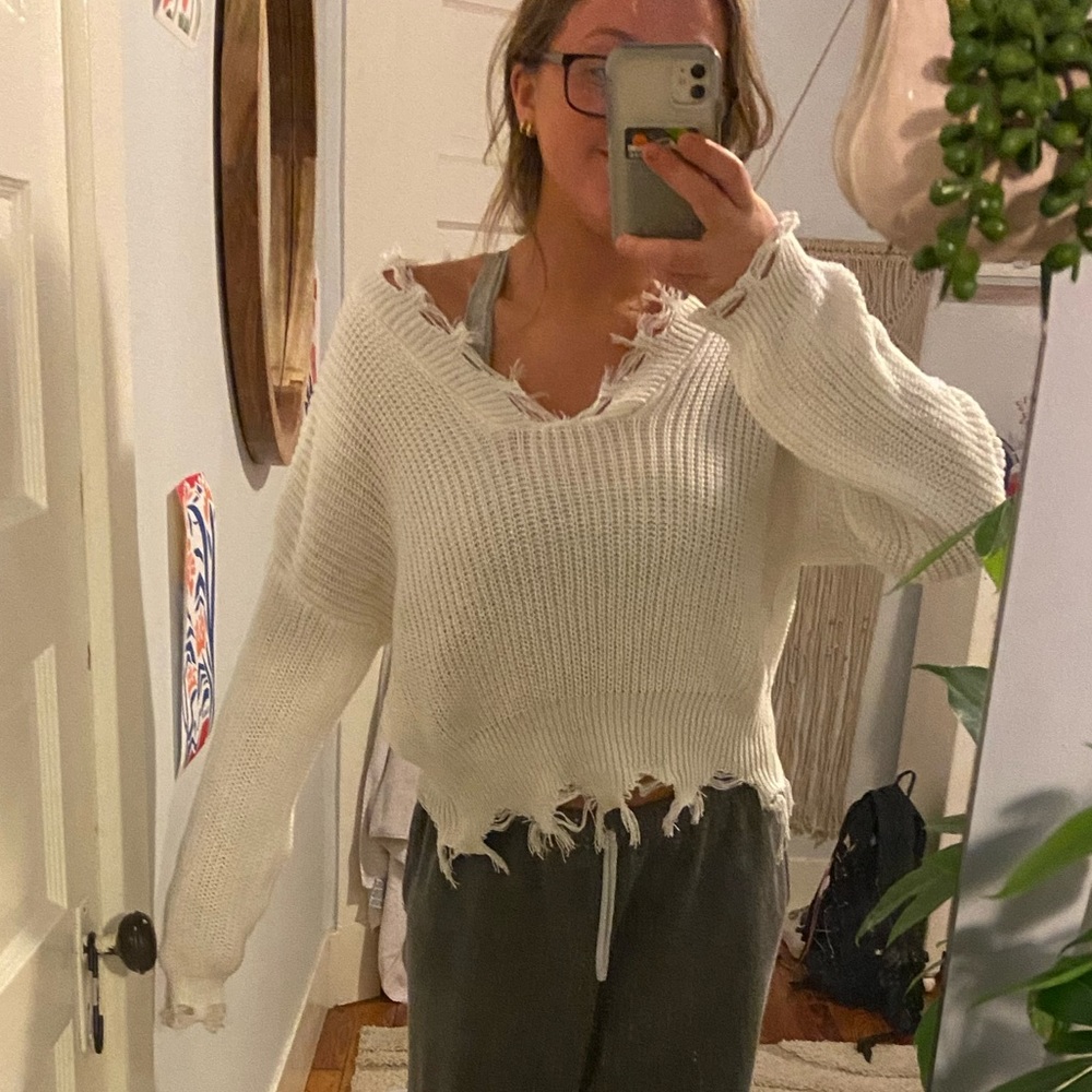 White slouchy sweater with distressed edges